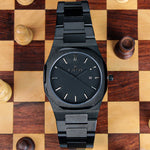 Reloj negro con 3 manecillas negras y dial negro con fecha